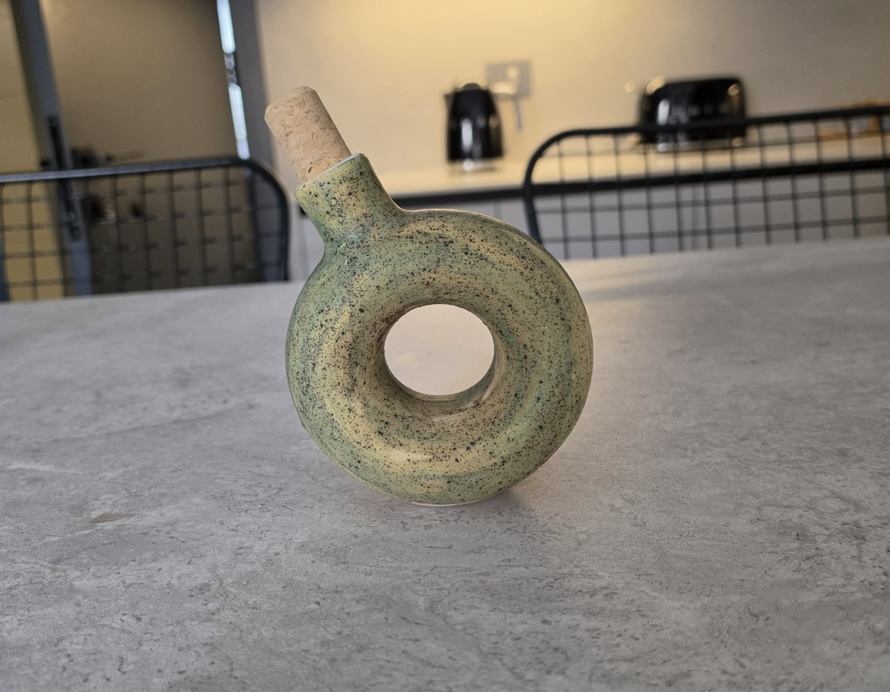 A speckled green Moon bottle on a kitchen counter