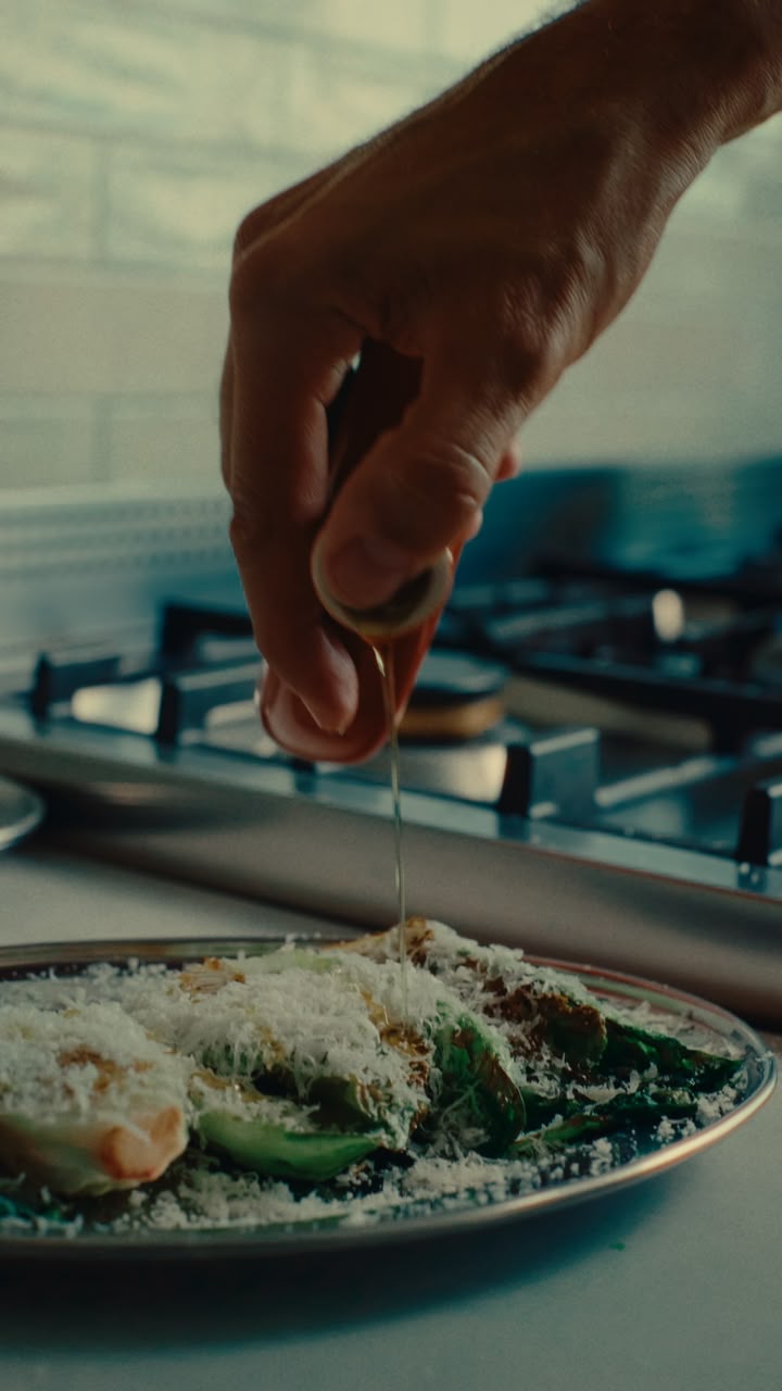 A finishing drizzle of olive oil over a freshly prepared plate